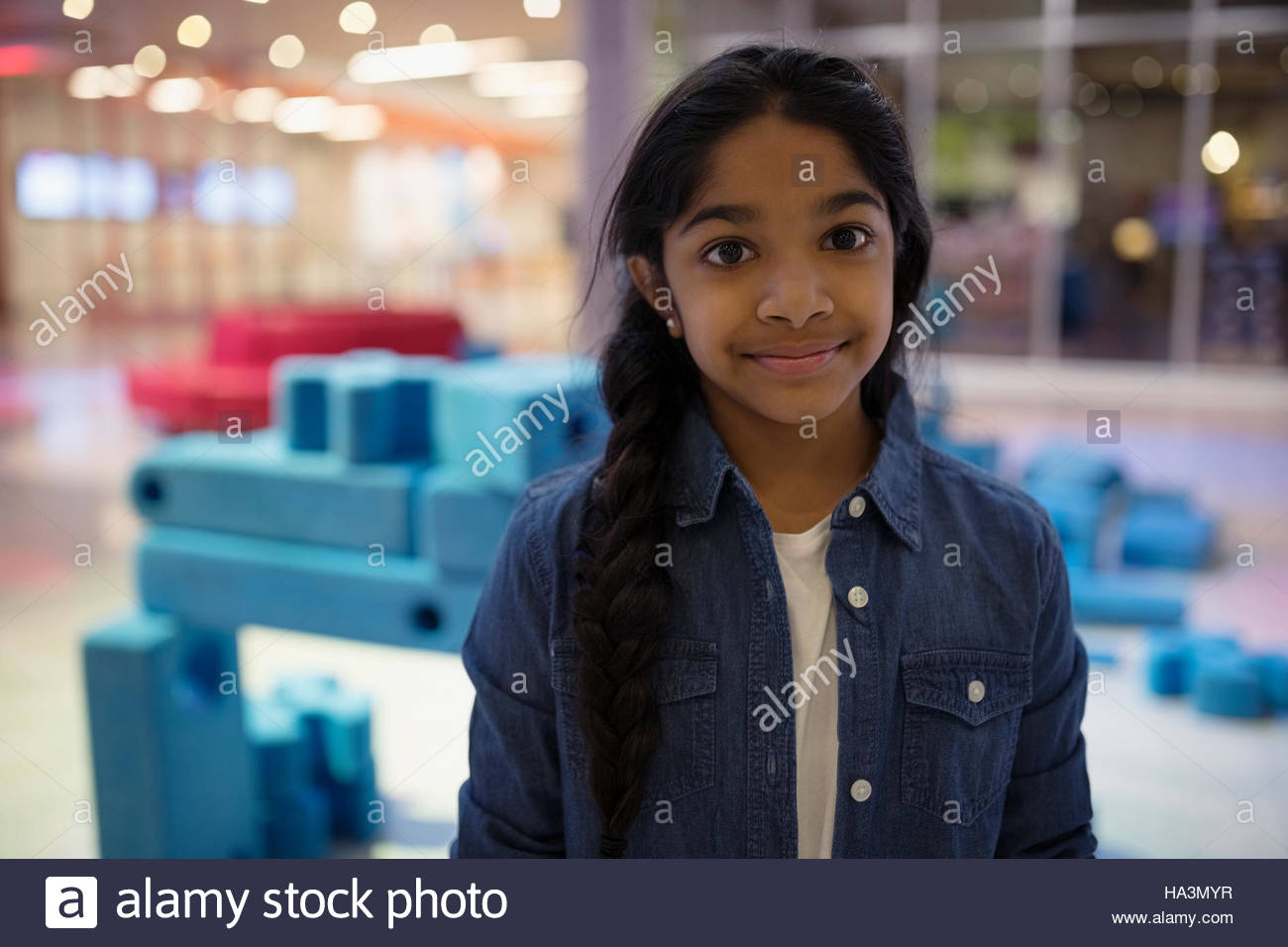 Portrait smiling girl in science center Stock Photo - Alamy