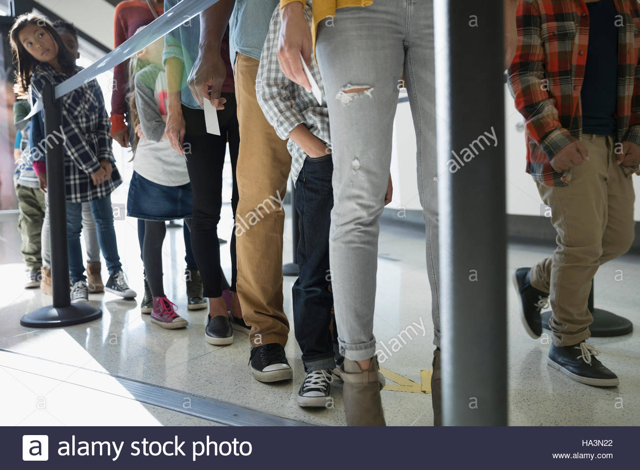 Parents and children waiting in queue at science center Stock Photo Alamy
