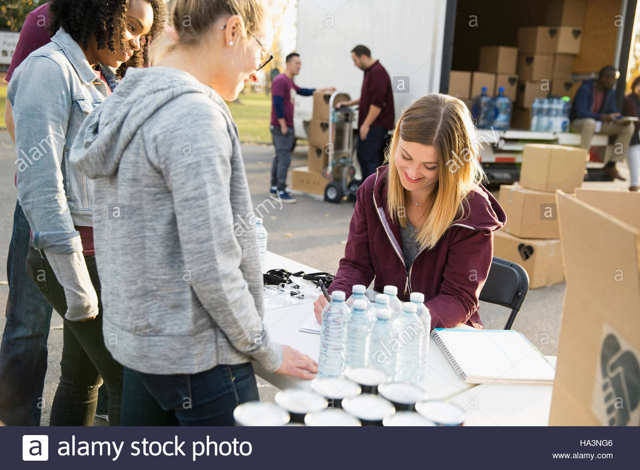 Volunteers checking in at table Stock Photo Alamy