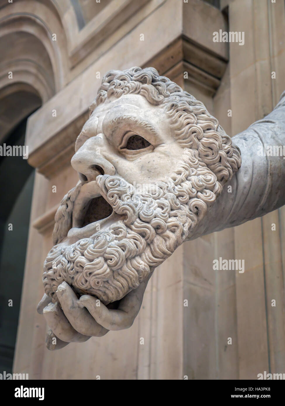 Closeup of tragic mask held my muse Melpomene. Marble artwork, Louvre Museum Stock Photo