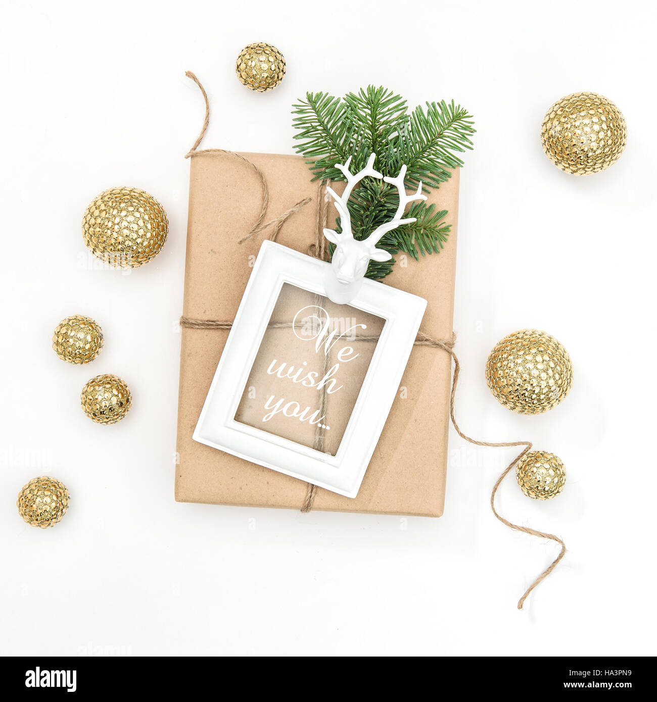 Christmas composition with gift, picture frame and golden decoration on white background. Square image perfect for social media Stock Photo