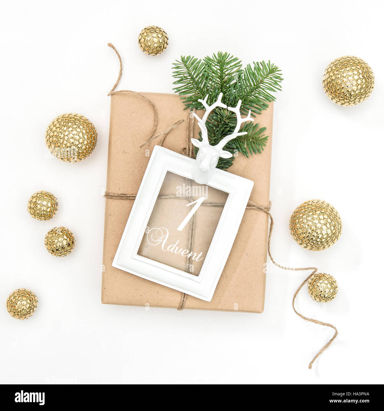 Christmas composition with gift, picture frame and golden decoration on white background. 1. Advent Stock Photo