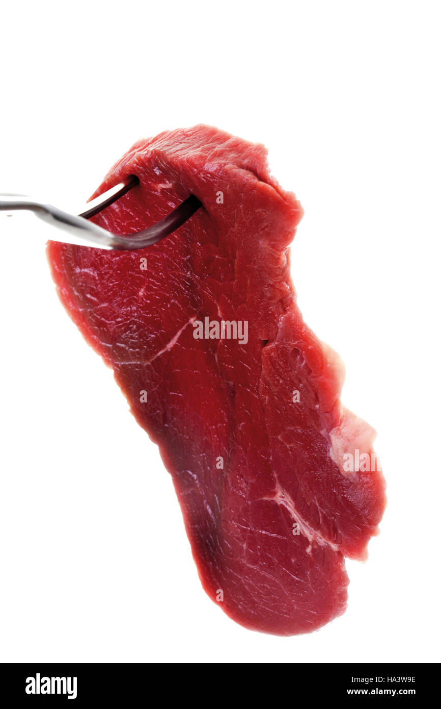 Beef minute steak on a meat fork Stock Photo Alamy