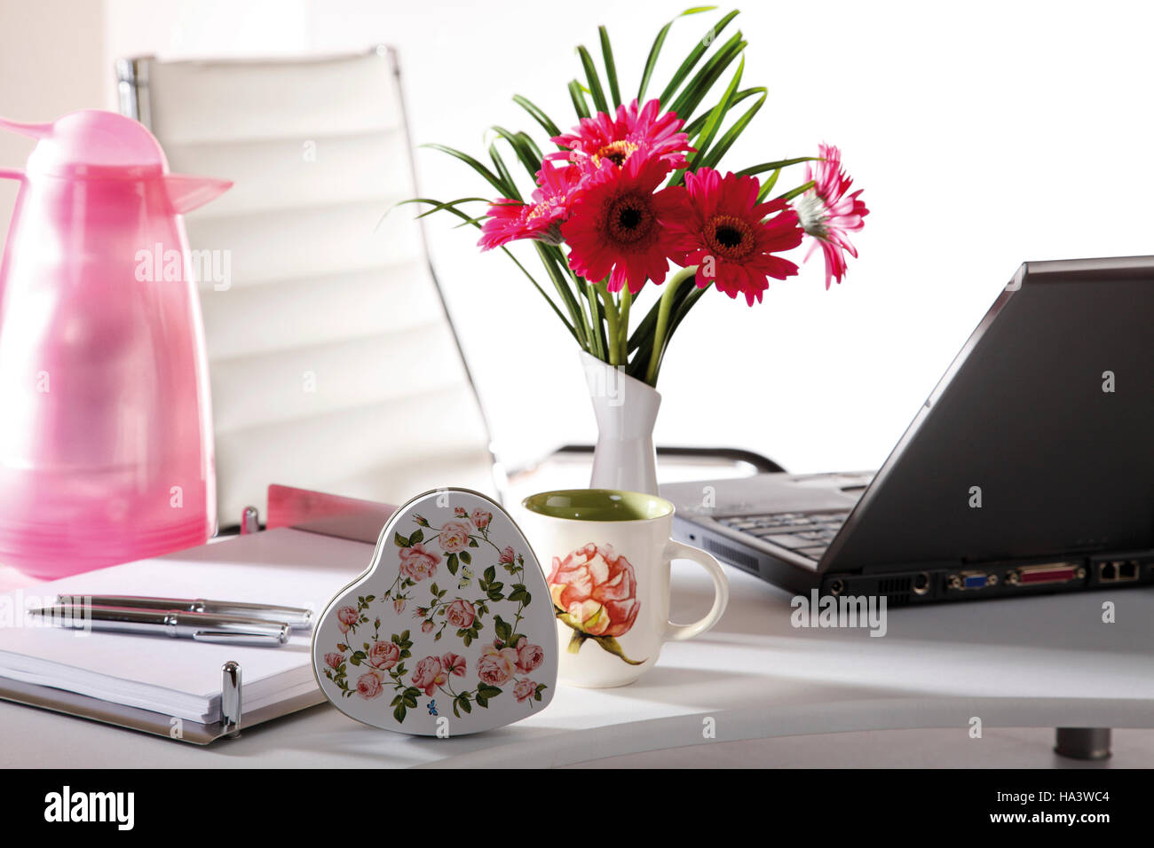 Desk, small flower bouquet and a parcel Stock Photo