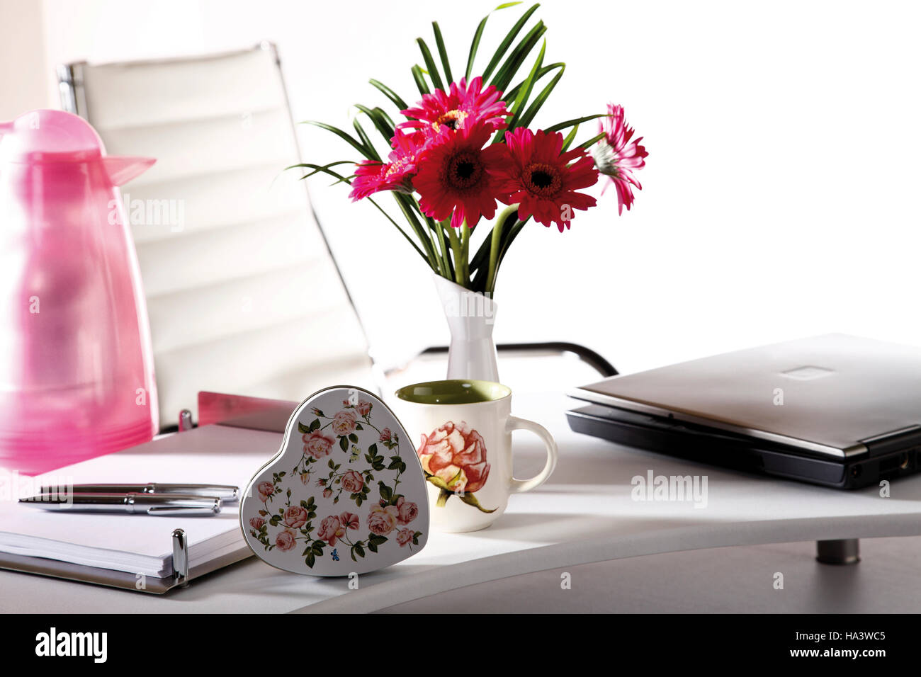 Desk, small flower bouquet and a parcel Stock Photo