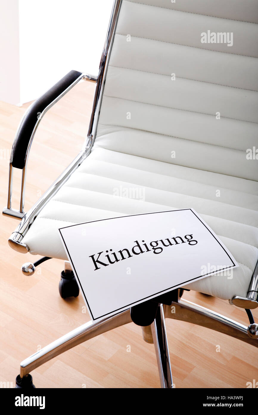 White office chair, "Kuendigung", "dismissal" in writing Stock Photo