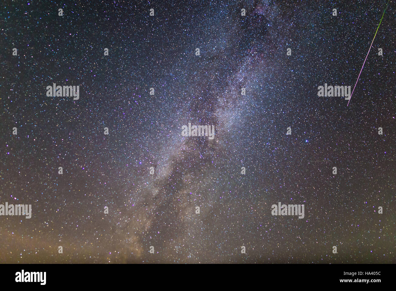 A meteor from the Perseid Meteor Shower can be seen passing near the