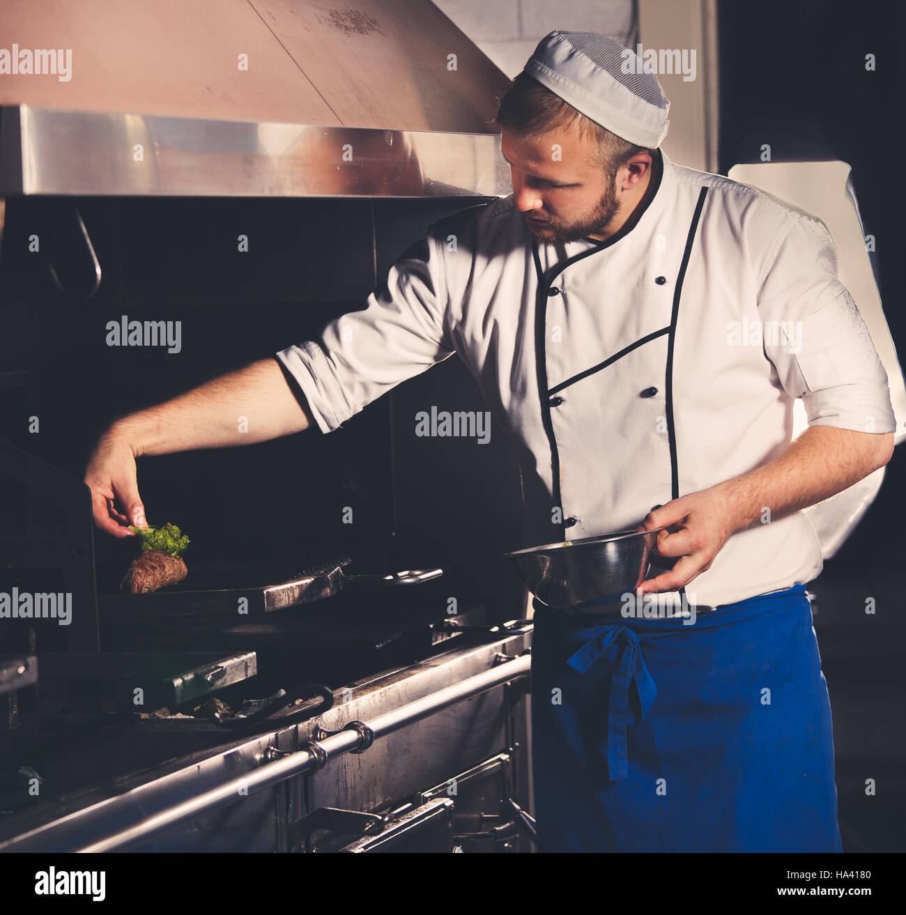 young chef preparing meat Stock Photo