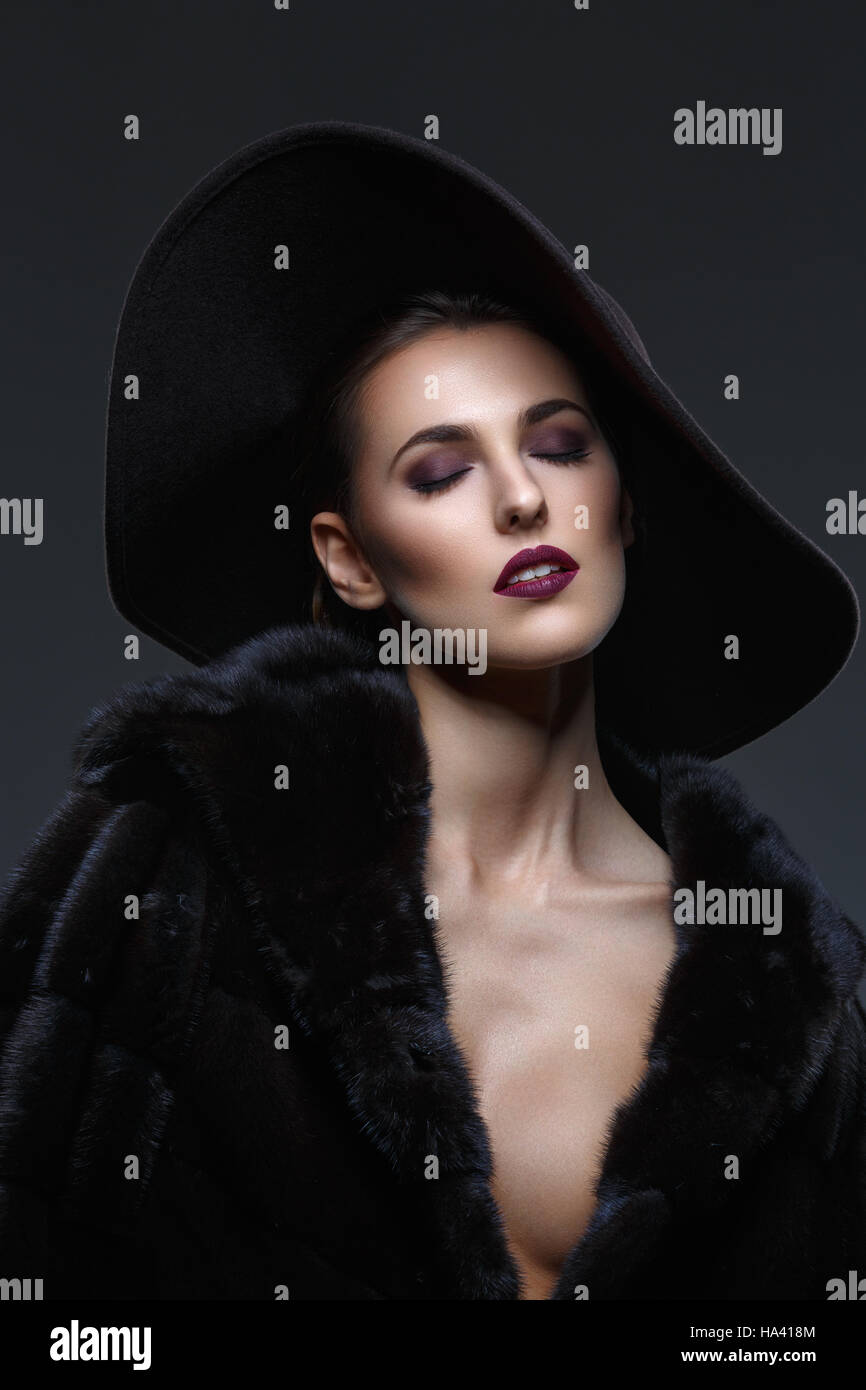 Beautiful girl in fur coat and hat Stock Photo - Alamy