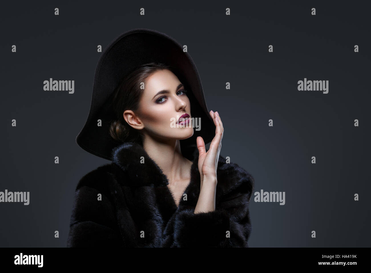 Beautiful girl in fur coat and hat Stock Photo - Alamy