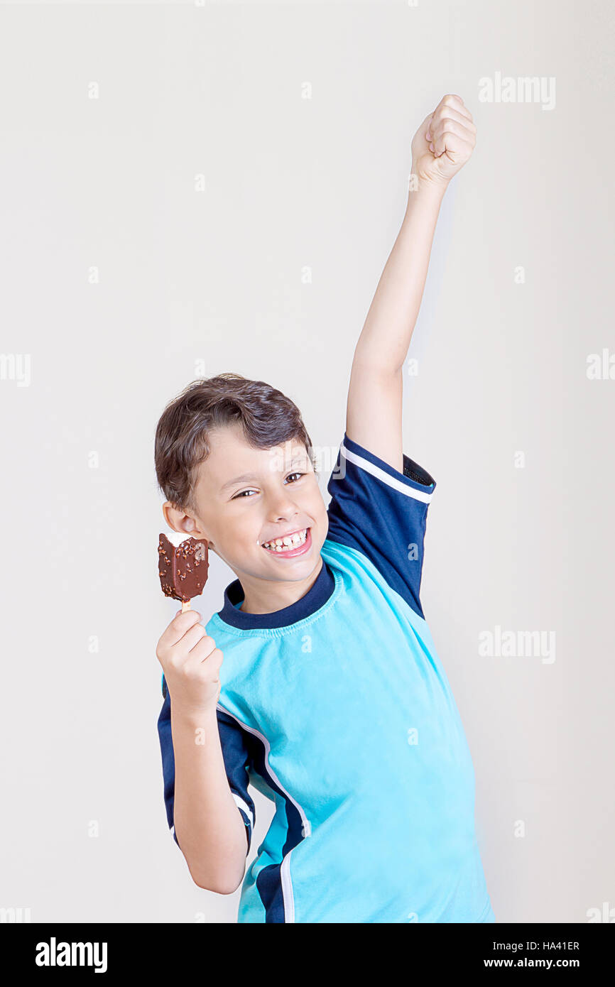 Young kid feeling happy with chocolate ice cream bar Stock Photo