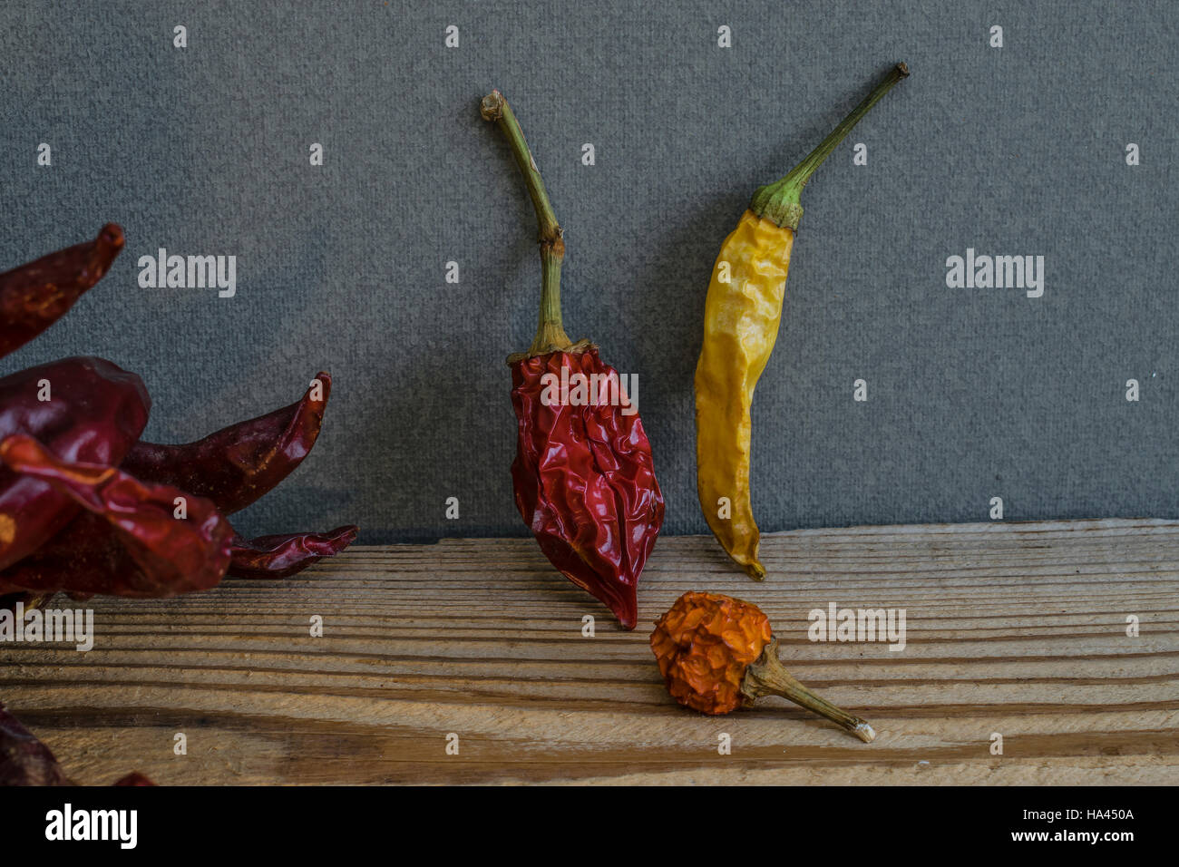 Hot dry peppers on wooden table leaning against the wall Stock Photo ...