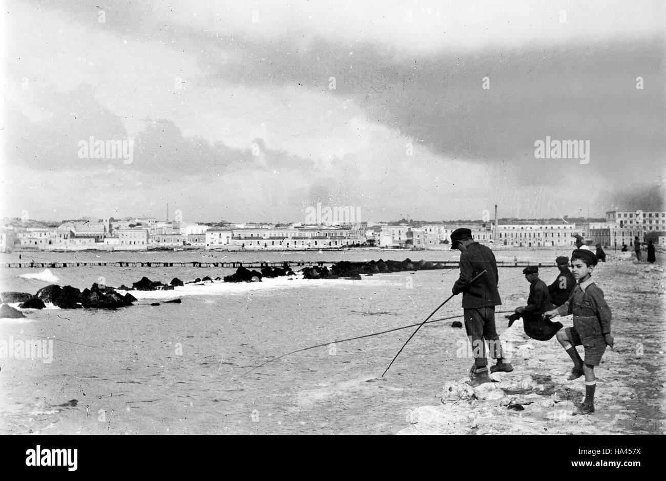 Children fishing in Syracuse Sicily Italy 1925 Stock Photo