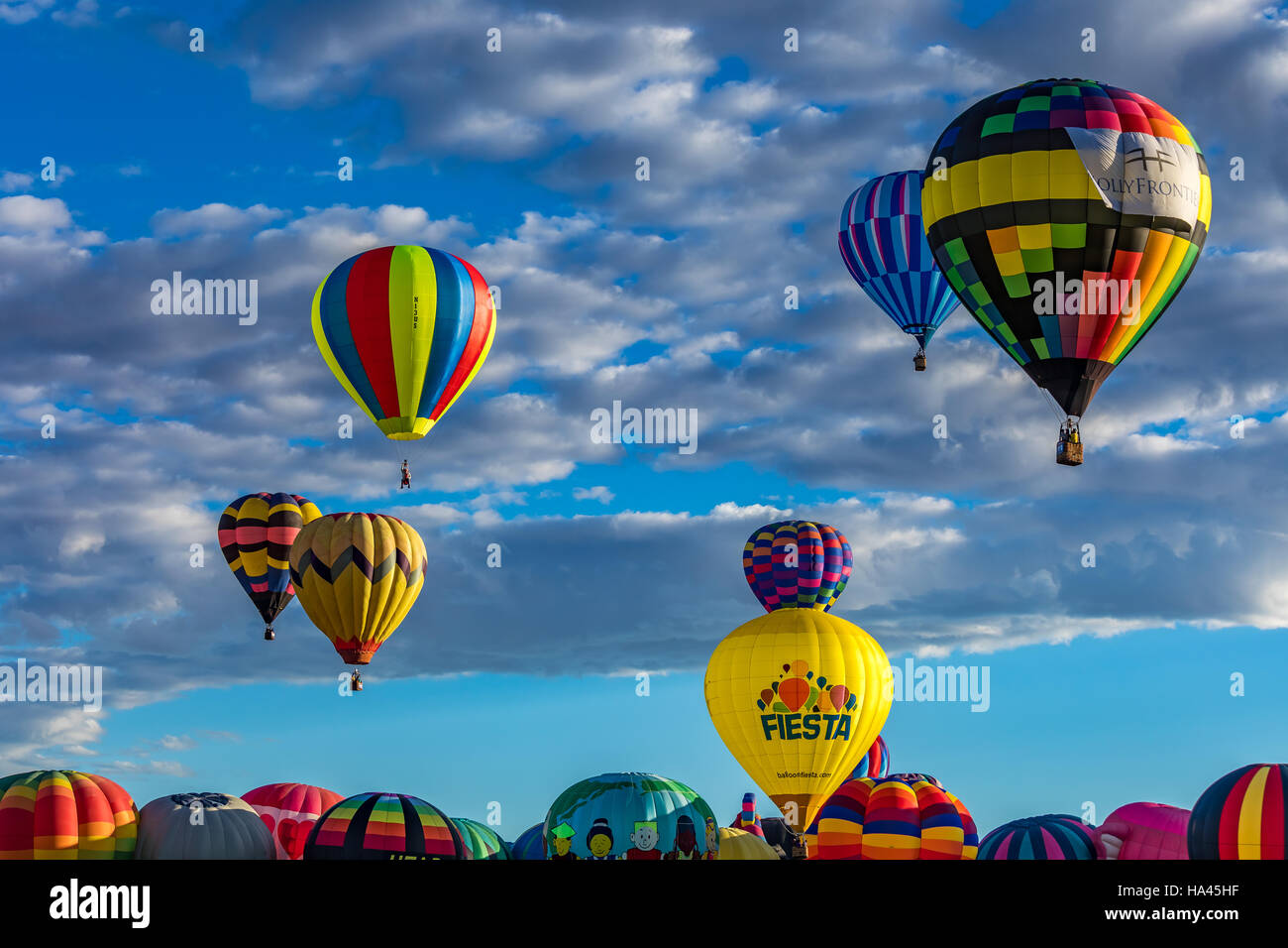 Hot Air Balloons fly over the city of Albuquerque, New Mexico during the mass ascension at the annual Hot Air Balloon Fiesta Stock Photo