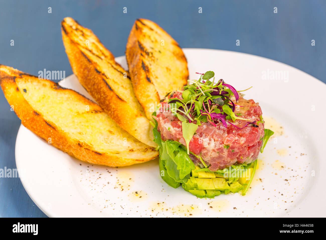 Ahi tuna tartare stacked with avocado, arugula, topped with micro