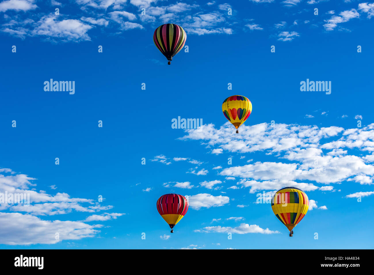 Hot Air Balloons fly over the city of Albuquerque, New Mexico during the mass ascension at the annual International Hot Air Balloon Fiesta in October Stock Photo