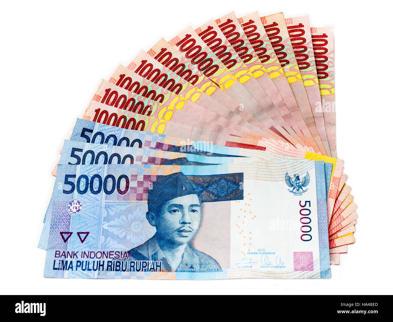 Piles of Indonesian Rupiah (IDR) banknotes on the white background ...