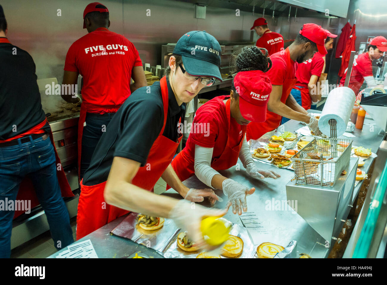 Paris, France, Group of Diverse French People, Teenagers, Working in Kitchen inside American Fast Food Restaurant, 'Five Guys', france multicultural g Stock Photo