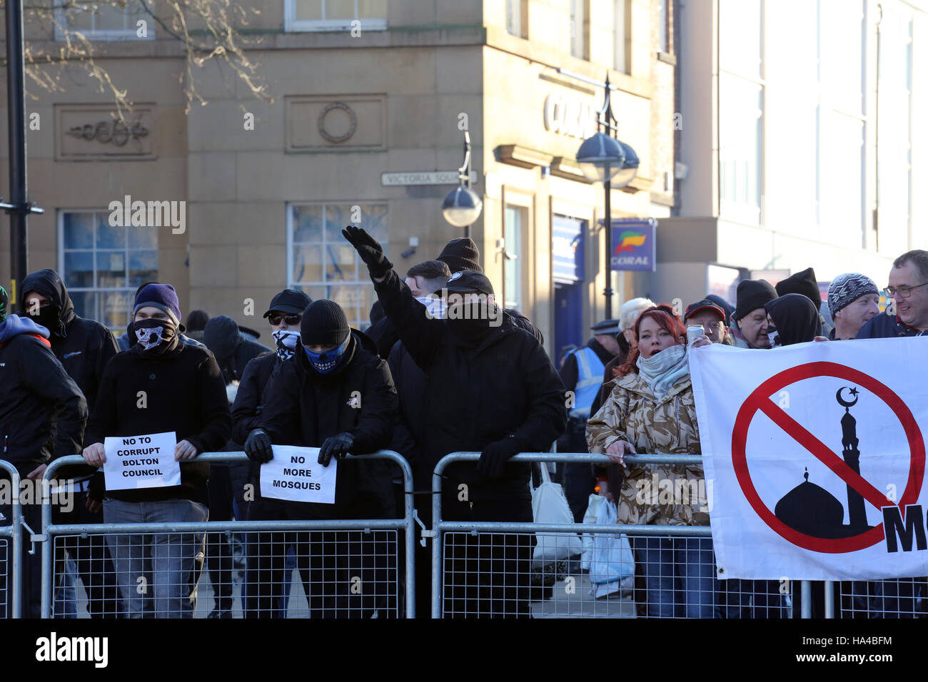 Bolton, Lancashire, UK. 26th November, 2016. Masked right wing protesters next to a banner with an anti Mosque sign painted on it, Bolton, Lancashire, UK. 26th Nov, 2016. Credit:  Barbara Cook/Alamy Live News Stock Photo