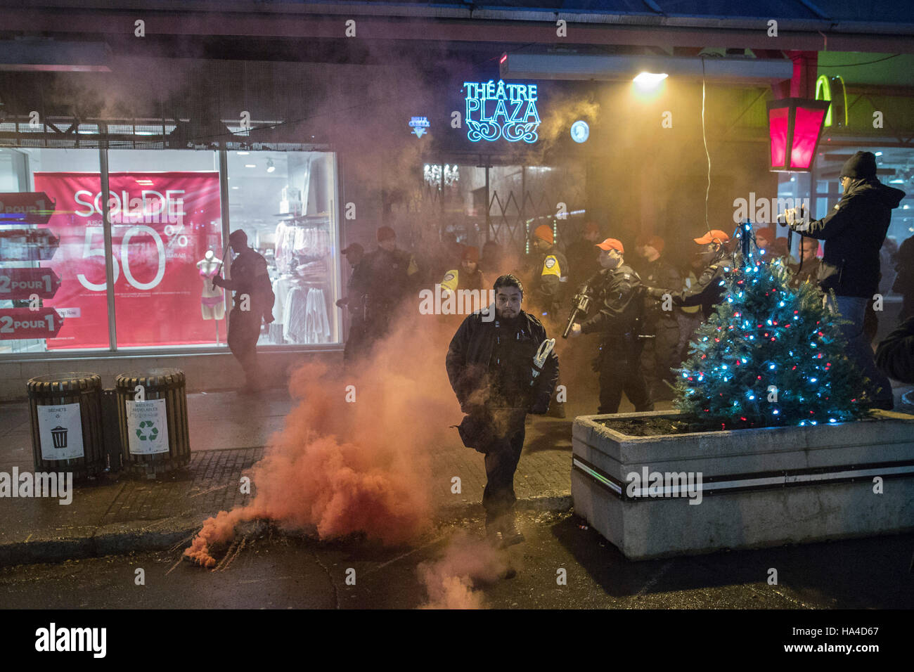 Montreal, Quebec, Canada. 26th November, 2016. Police outside the Theatre Plaza after demonstrators clashed with police and security in protest against a concert by Polish black metal rock band Graveland. Protesters labelling themselves 'anti-fascists militants' were protesting what they call a racist band. Dario Ayala/Alamy Live News Stock Photo