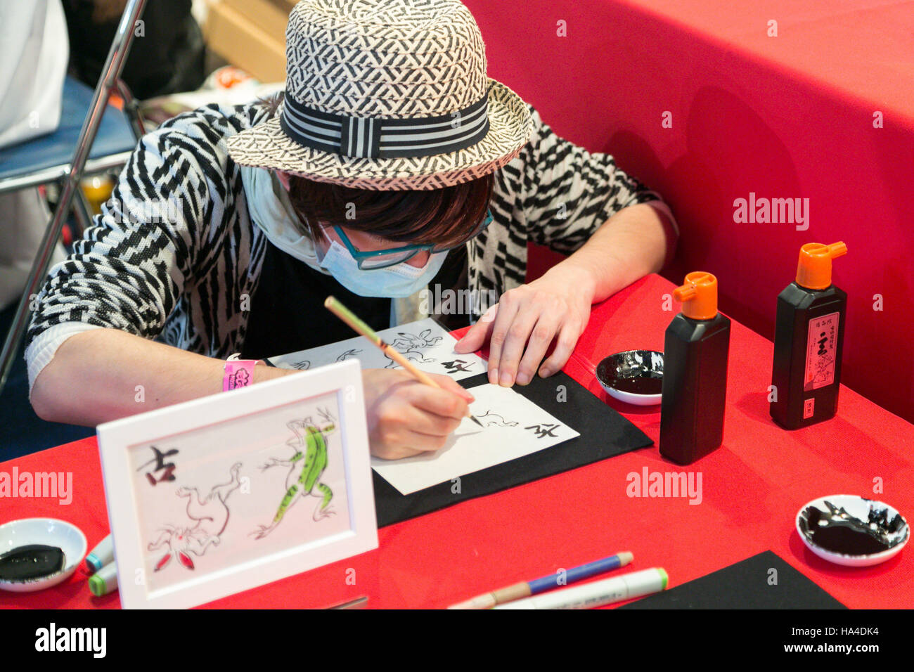 A man draws a traditional Japanese picture during the Moshi Moshi Nippon Festival 2016 on November 26, 2016 in Tokyo, Japan. Moshi Moshi Nippon Festival 2016 aims to promote Japanese pop culture (fashion, anime, technology, music and food) to the world, and non-Japanese visitors are able to enter the event for free by showing their passport. This year's two day event included live shows by Japanese pop stars Silent Siren, Dempagumi.inc, Tempura Kids, Capsule and Kyary Pamyu Pamyu at the Tokyo Metropolitan Gymnasium. © Rodrigo Reyes Marin/AFLO/Alamy Live News Stock Photo
