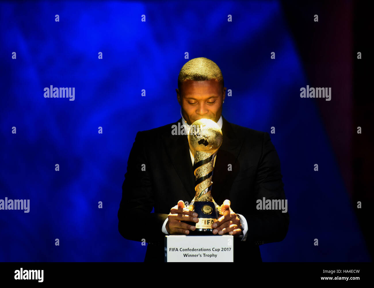 Kazan, Russia. 26th Nov, 2016. Brazilian soccer player Julio Baptista brings the trophy on stage during the official draw ceremony for Confederations Cup 2017 in Kazan, Russia, Nov. 26, 2016. © Evgeny Sinitsyn/Xinhua/Alamy Live News Stock Photo