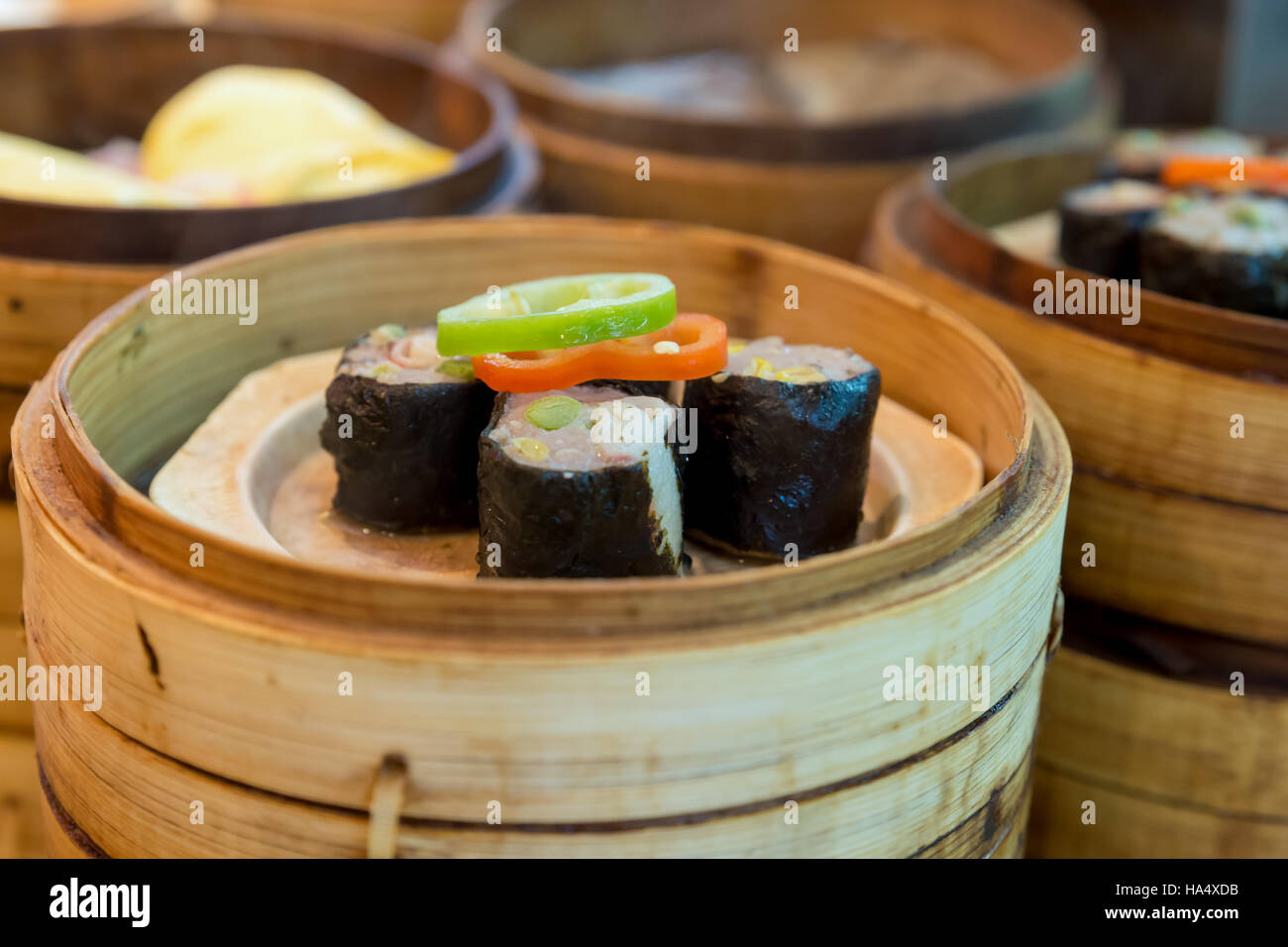 Chinese steamed dumpling in bamboo basket in Chinese food restaurant at Shanghai, China. Stock Photo