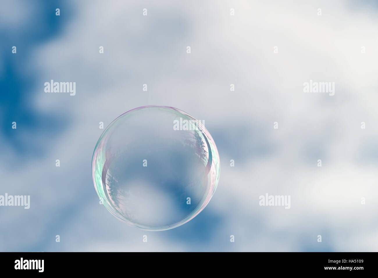 Soap bubble flying in blue sky with clouds Stock Photo - Alamy