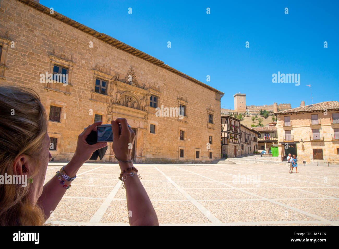 Mature woman taking photos in the Main Square. Peñaranda de Duero, Burgos province, Castilla Leon, Spain. Stock Photo