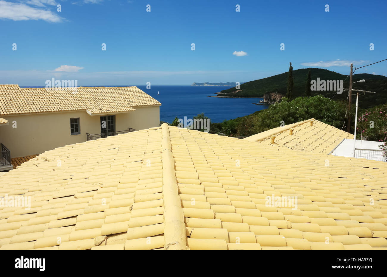 Yellow roofs and blue Ionian Sea in Greece. Stock Photo