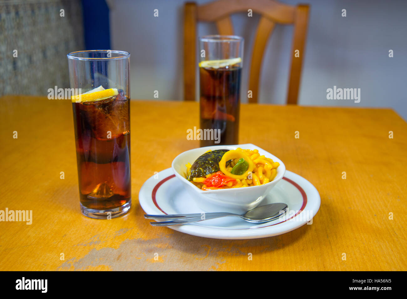 Spanish aperitif two glasses of vermouth and tapa of fideua in a bar