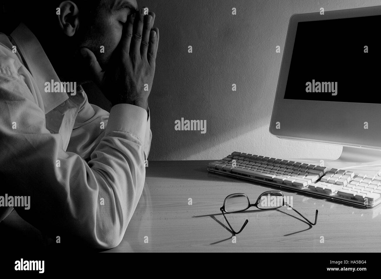 Tired man at the computer. Black and white Stock Photo - Alamy
