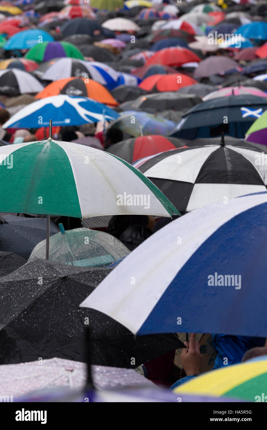 People queuing to get into Waterloo Railway station during a rain storm, London, Britain Stock Photo