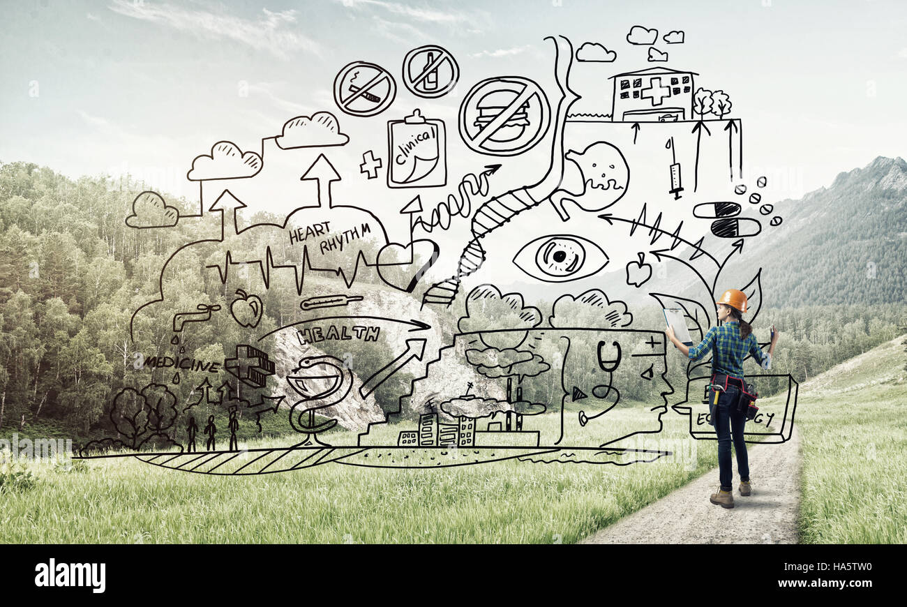 Back view of engineer woman in hardhat outdoor and sketched concept on ...