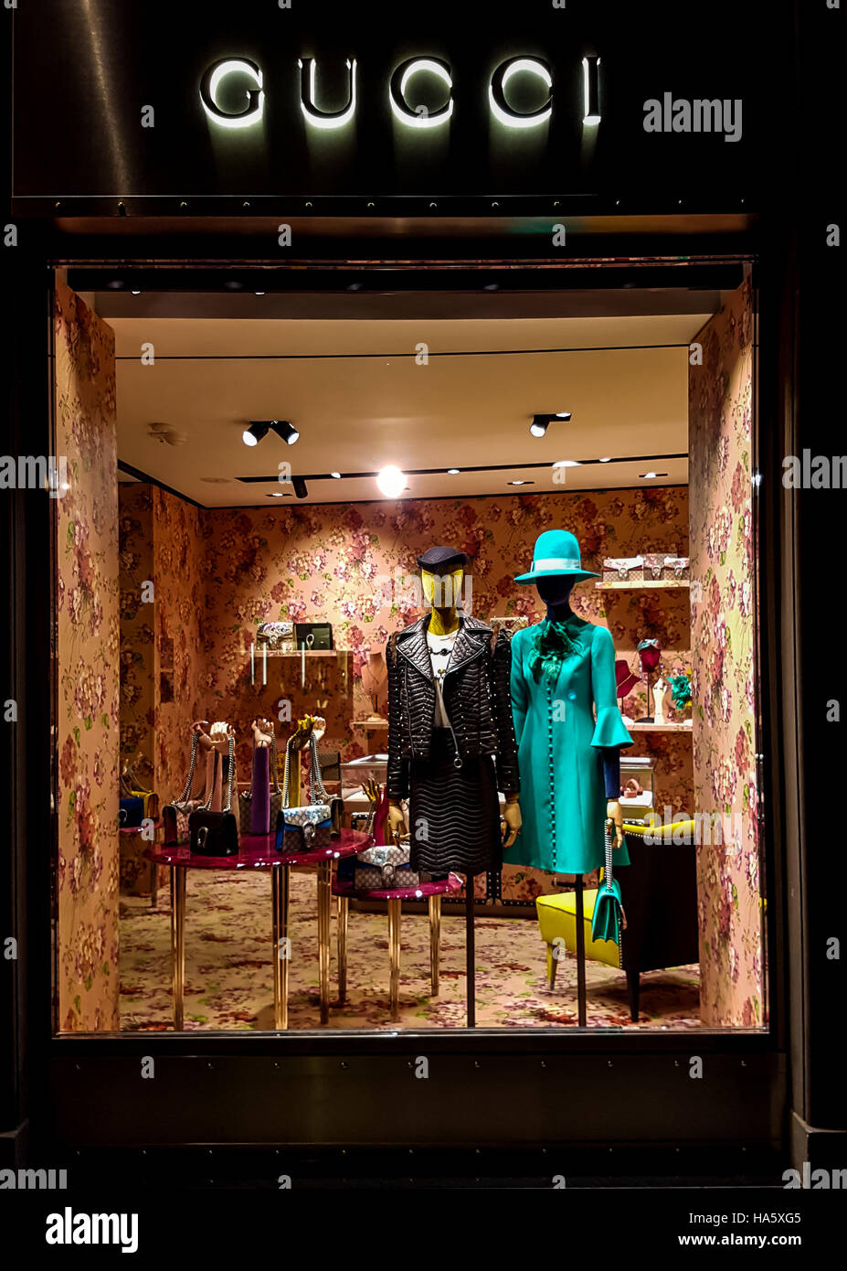 Gucci luxury bags, clothes and shoes sit displayed for sale inside a Gucci store in Florence, Italy Stock Photo