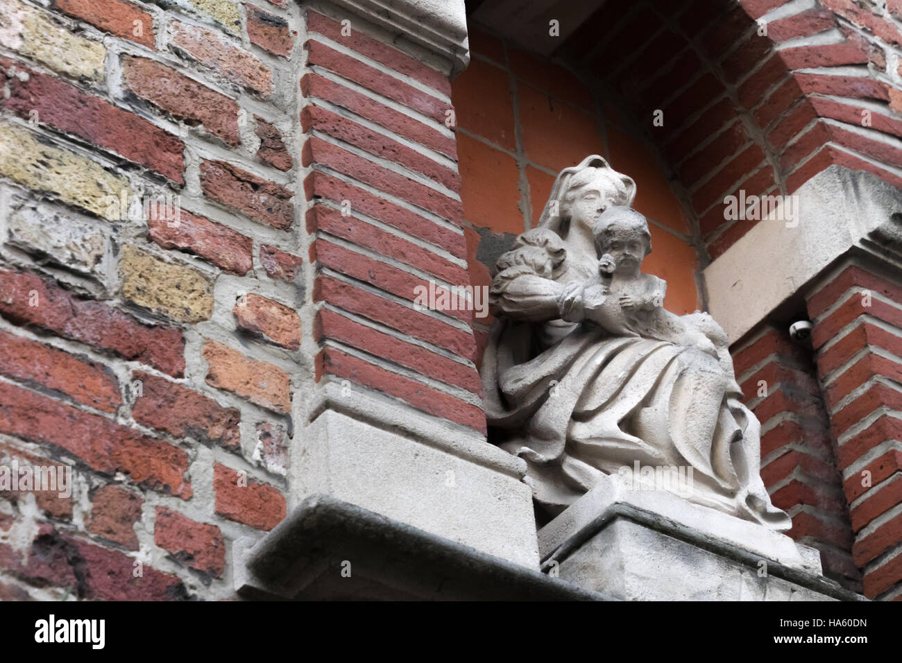 Madonna and child statue in brick archway Bruges Stock Photo