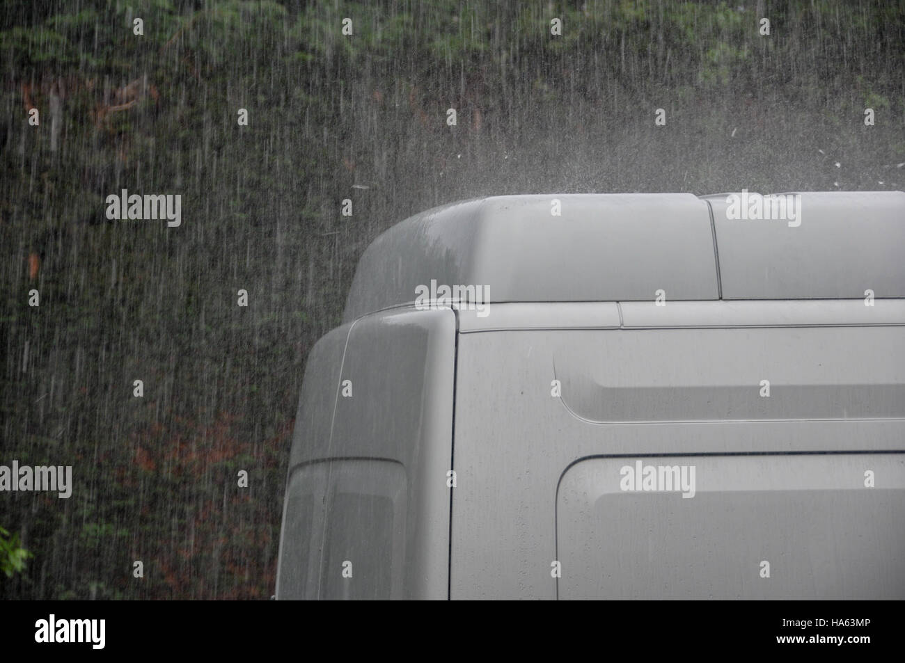Heavy rain bouncing off van roof Stock Photo