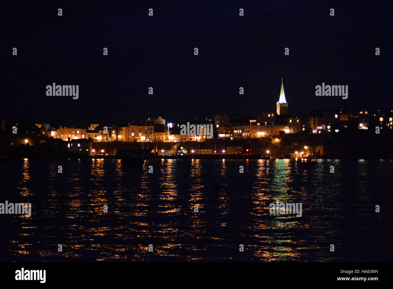 Tenby at night as seen from a yacht anchored in the bay Stock Photo