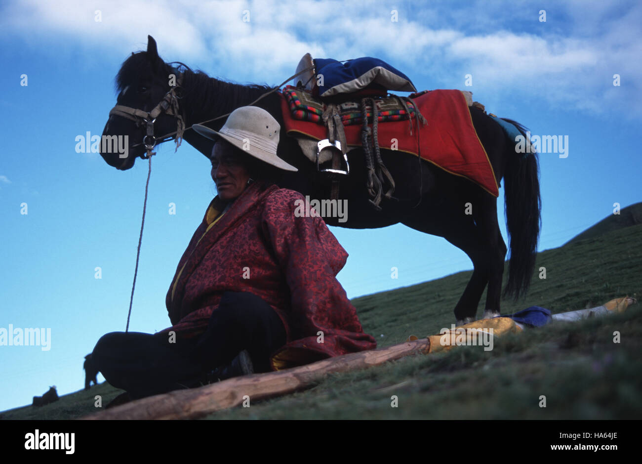 Caption: Ser'xu, Sichuan, China - Aug 2002. A Khampa man waits to ride in the opening ceremony of the Ser'xu Horseracing festival in eastern Tibet The Stock Photo