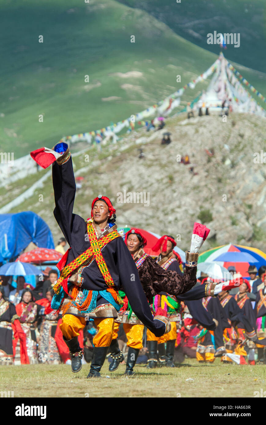 Khampa horseman performing traditional dance at the Yushu Horse Racing Festival. Qinghai, China. Stock Photo