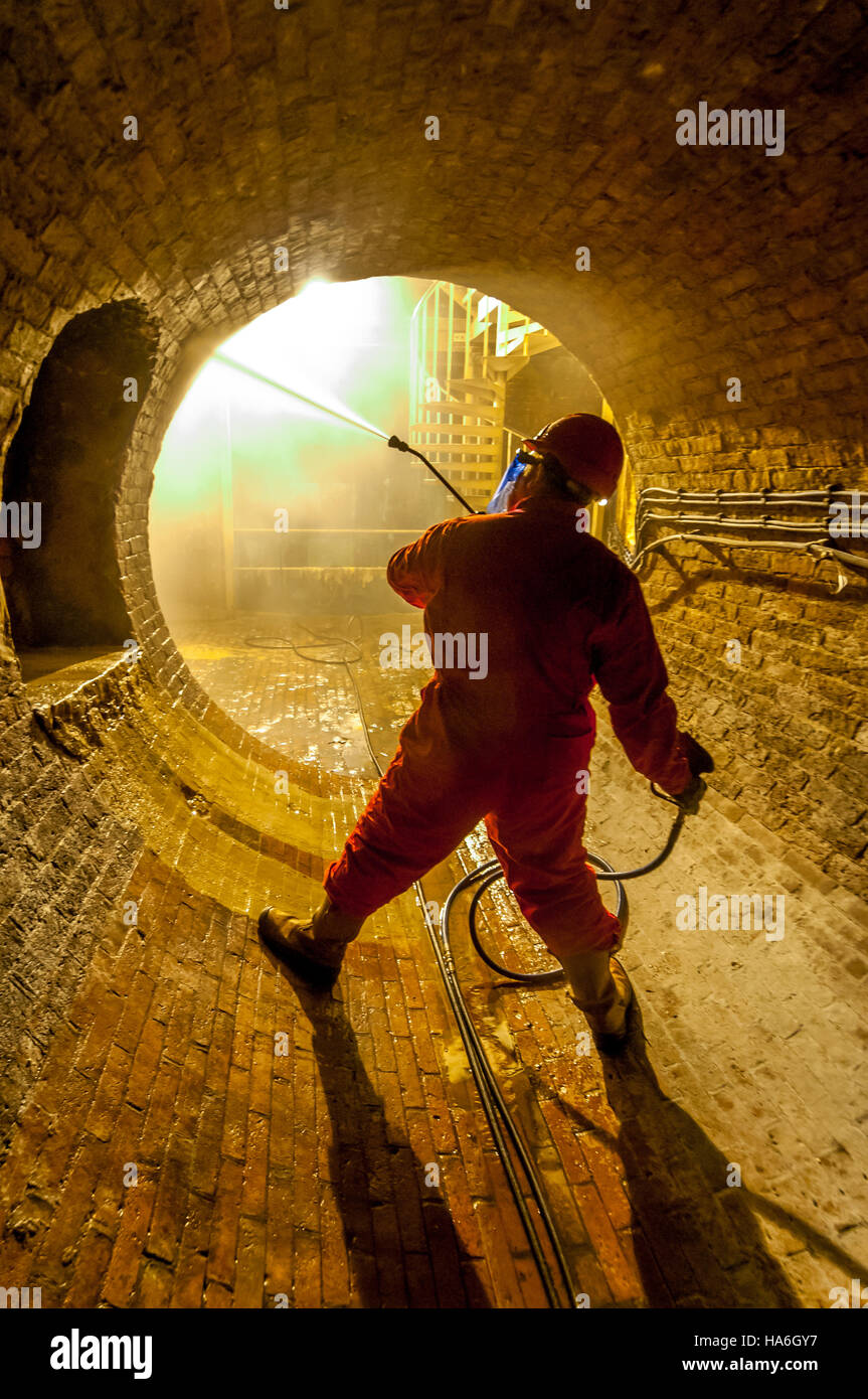 Operative Simon Judd cleaning part of Brighton’s Victorian sewer system, in readiness for this year’s tours of the underground i Stock Photo