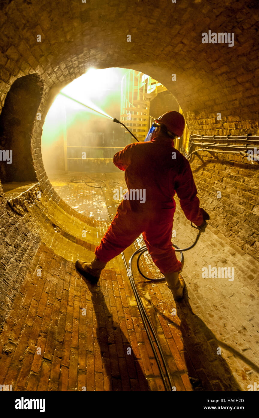 Operative Simon Judd cleaning part of Brighton’s Victorian sewer system, in readiness for this year’s tours of the underground i Stock Photo