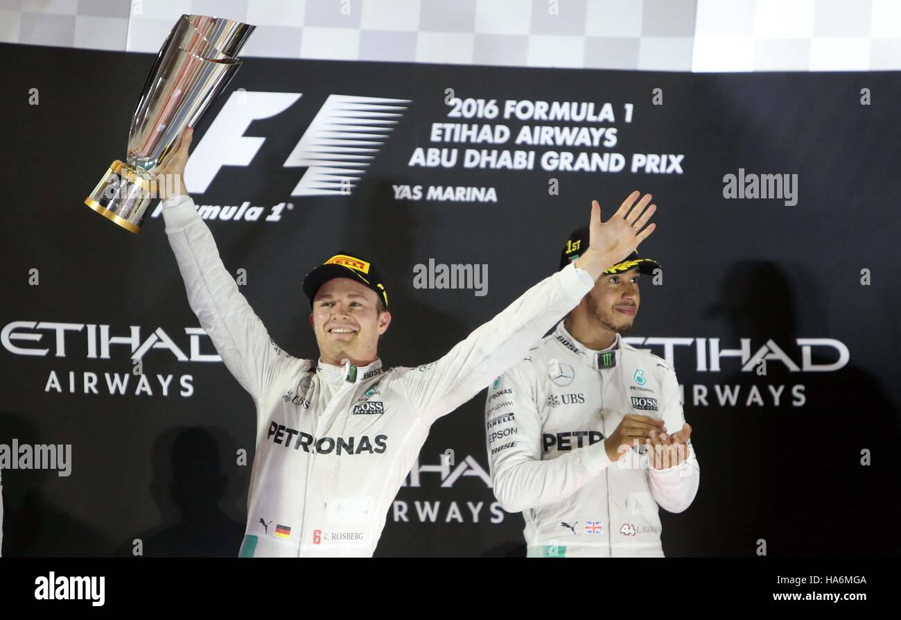 Mercedes Nico Rosberg celebrates winning the Formula One world championship on the podium with Lewis Hamilton right during the Abu Dhabi Grand Prix at the Yas Marina Circuit Abu Dhabi Stock Photo