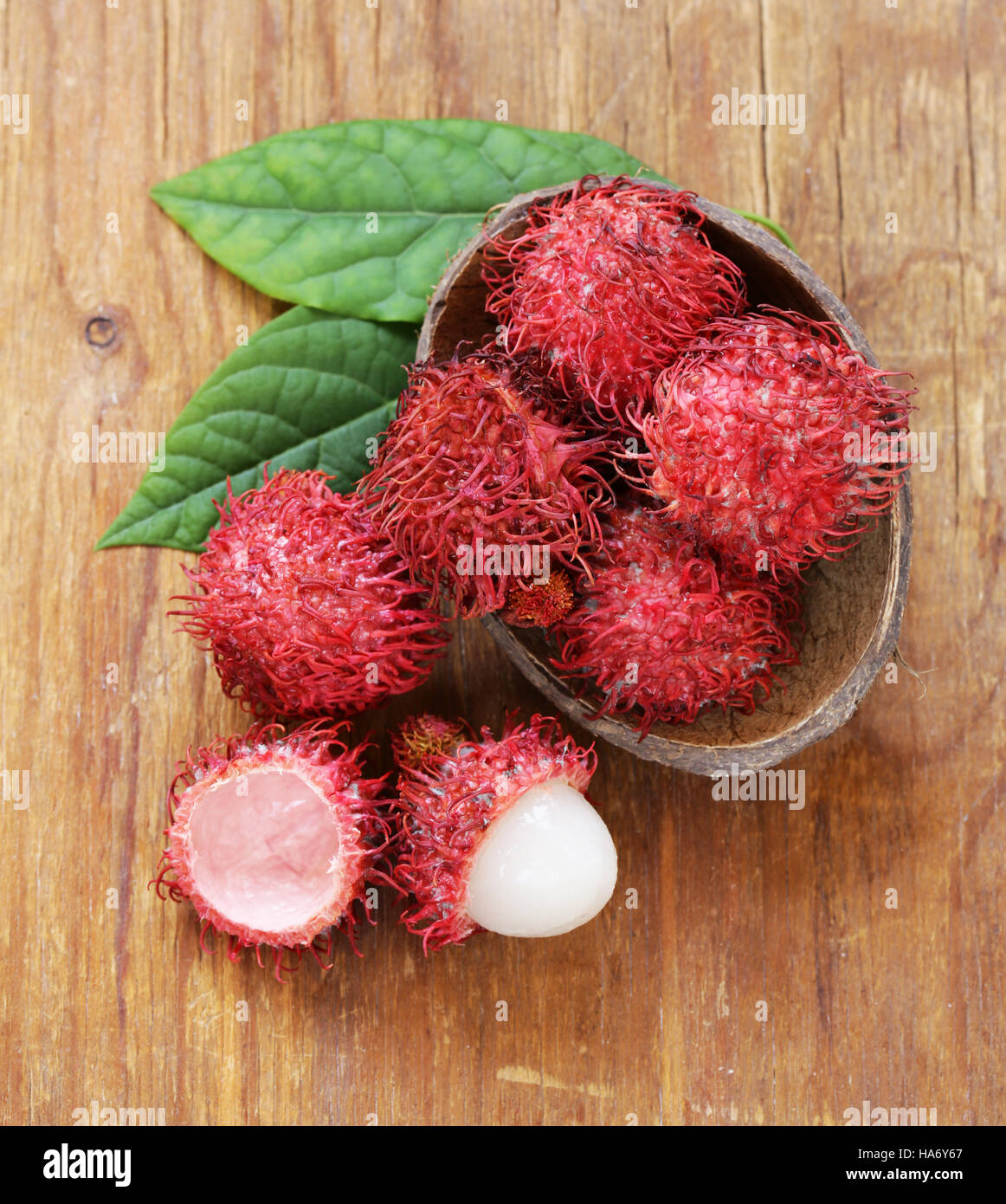 Natural organic lychee fruit (rambutan) on a wooden table Stock Photo