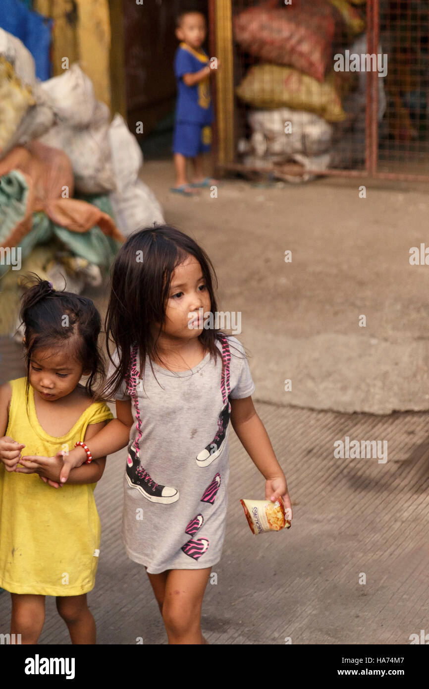 CEBU,PHILIPPINES-OCTOBER 18,2016: Little girl cares her sister in the carbon market on October 18, Cebu,Philippines. Stock Photo