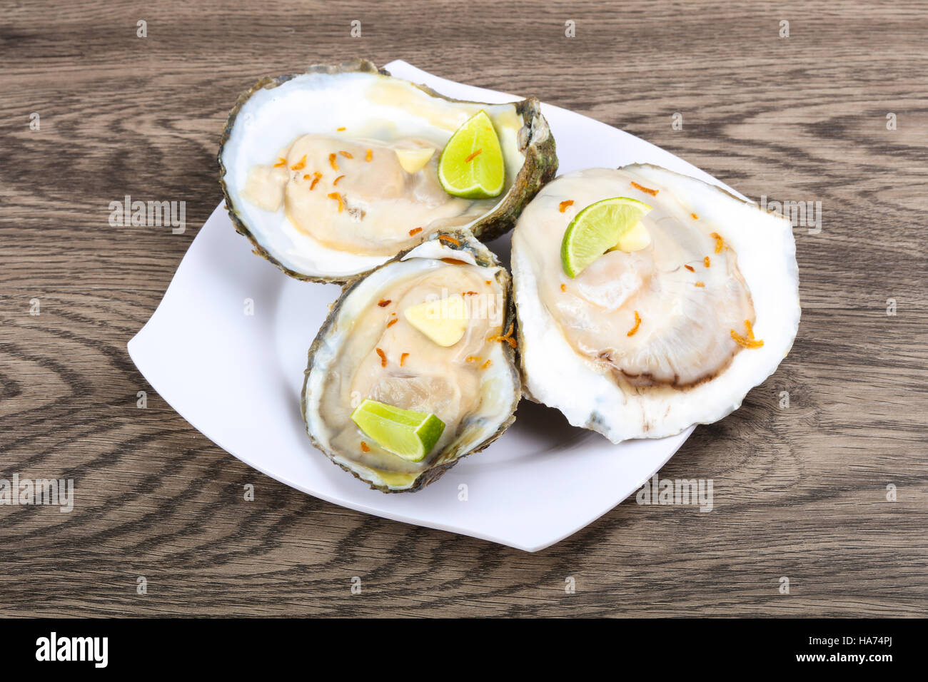 Raw oysters with lime and sliced garlik Stock Photo Alamy