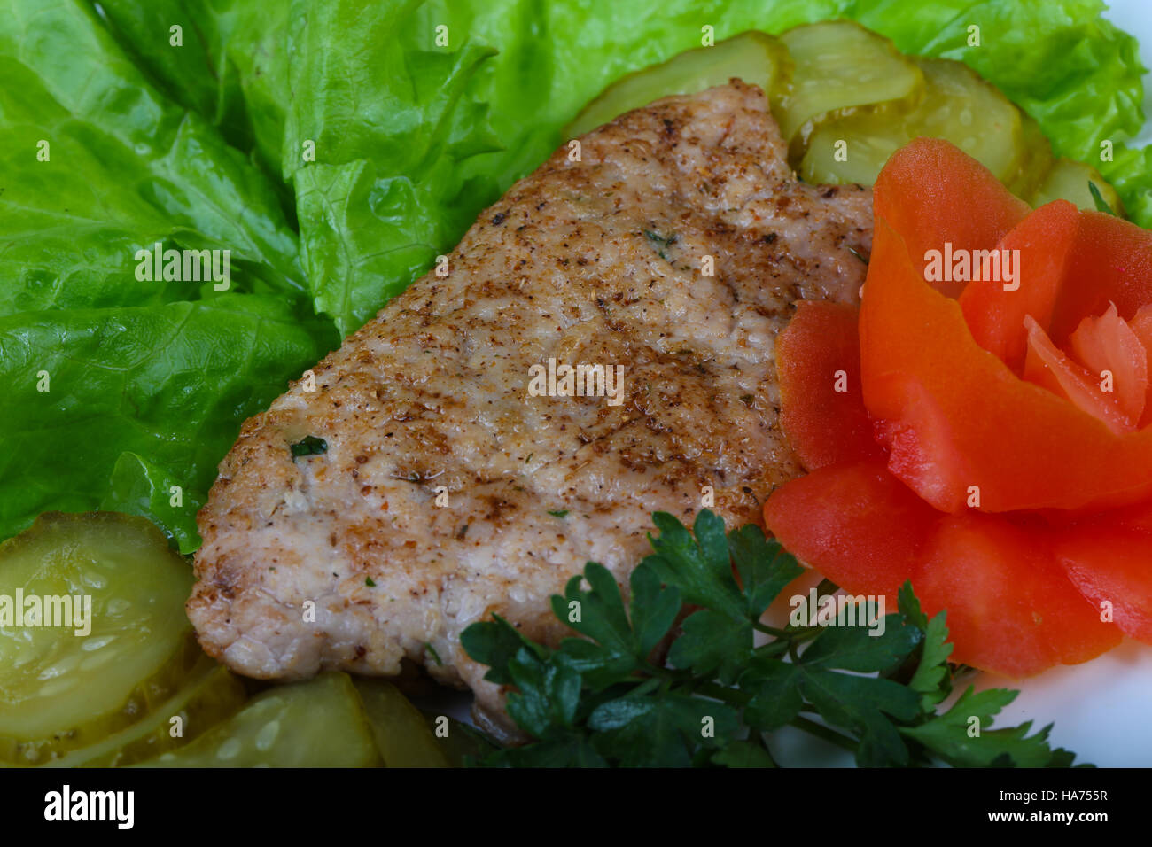 Roasted pork Schnitzel with salad leaves and pickled cucumber Stock