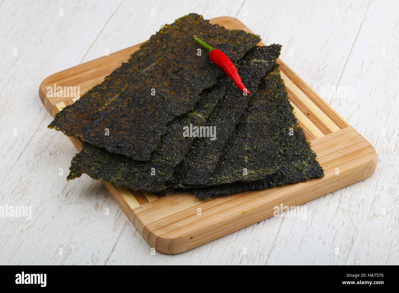 Spicy Nori seaweed sheets with pepper on wood Stock Photo Alamy