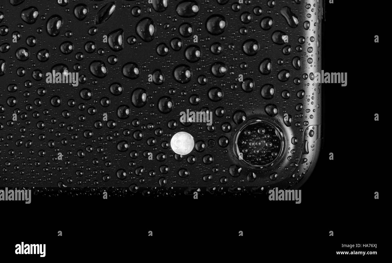 Black matte smartphone with waterdrops, isolated on white Stock Photo