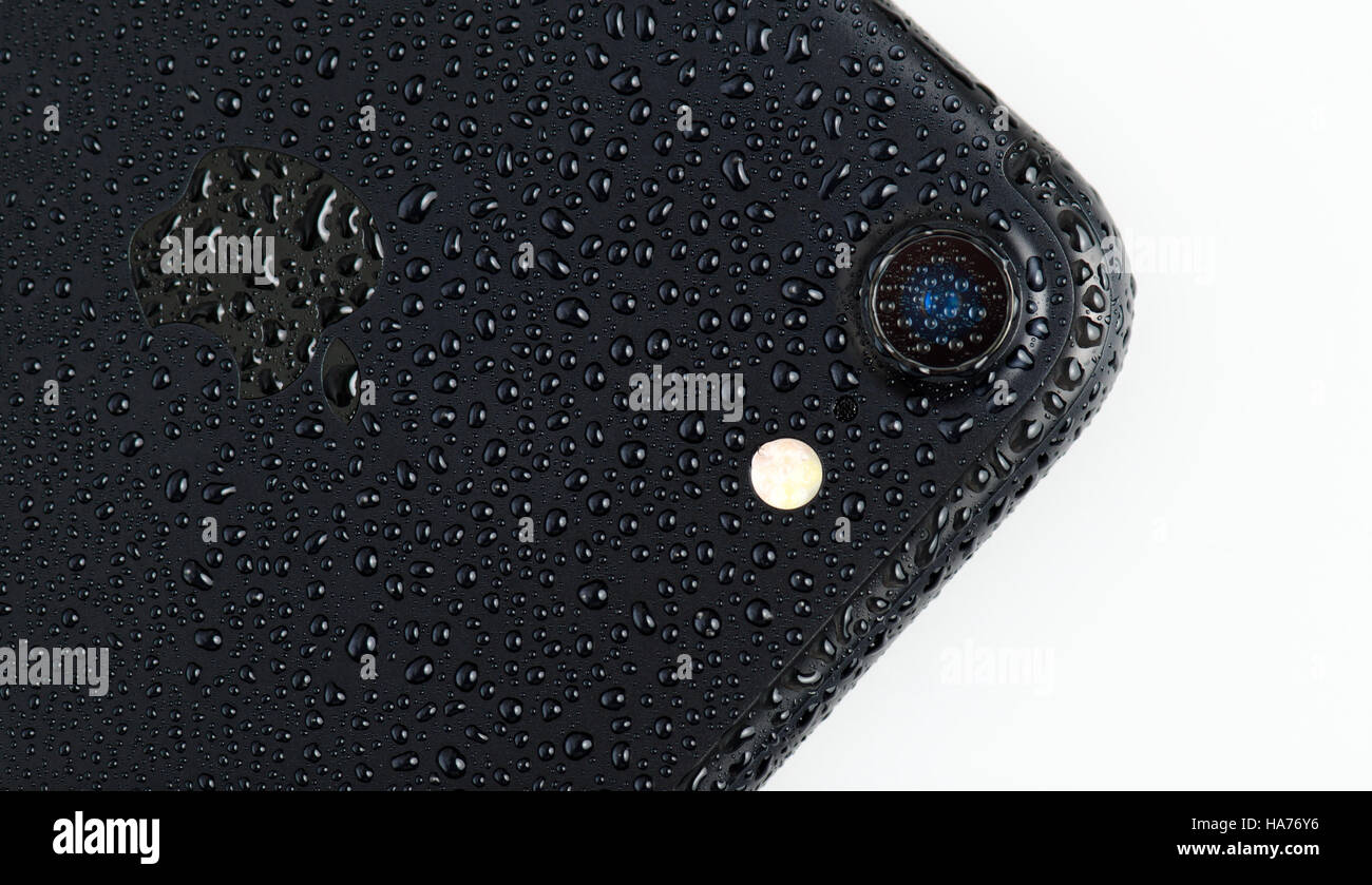 BRASOV, ROMANIA - 25 November 2016: iPhone 7 black matte with waterdrops on back and camera, isolated on white Stock Photo